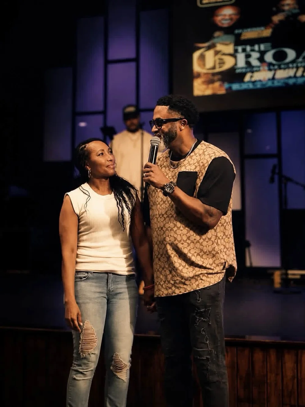 Dr. Wayland and Jeanette Henderson standing together on stage, hand in hand