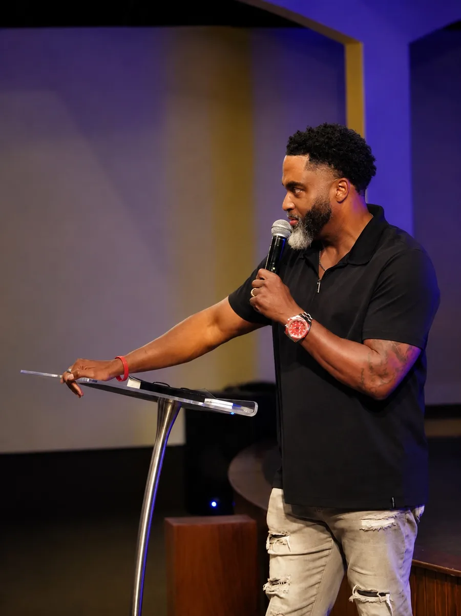 A speaker preaching from a podium